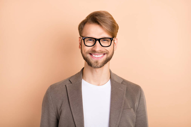 Photo of funky confident young gentleman dressed blazer glasses smiling isolated beige color background - Foto, Imagem
