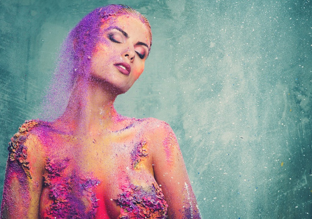 Beautiful young woman with conceptual colourful body art  - Photo, Image