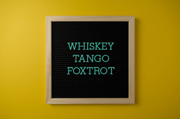 Whiskey Tango Foxtrot Sign no fundo amarelo - Foto, Imagem