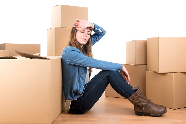 Tired girl with boxes - Foto, imagen