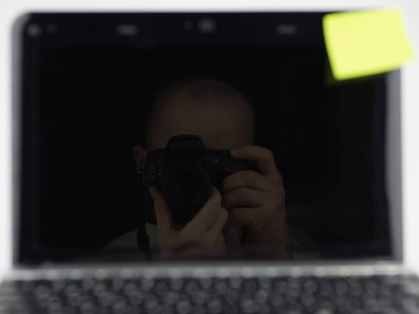 The photographer photographed his own reflection in the screen of the object - Photo, Image