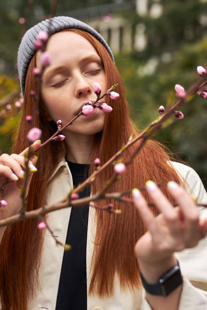 Calm Sensual Redhead Female Inhale The Smell Of Blooming Magnolia Tree - Valokuva, kuva