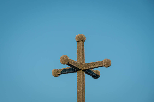 Votive cross covered with frost in a winter morning, icy cross against blue cloudless sky, closeup, decorative - Photo, Image
