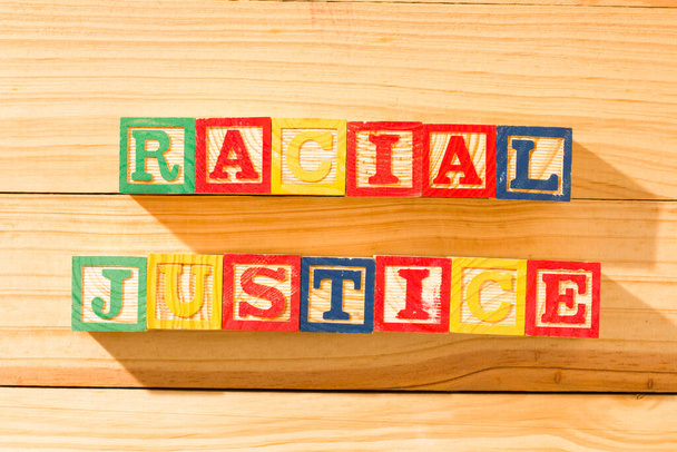Látványos fa kockák a szó RACIAL JUSTICE egy fa felületen. - Fotó, kép