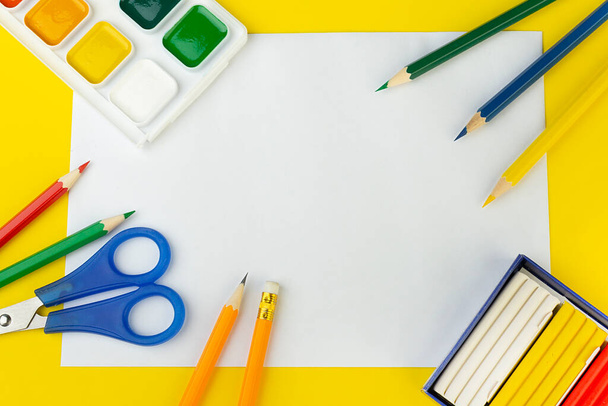 school supplies top view on a yellow background, with a place to write, close-up - Foto, Imagen