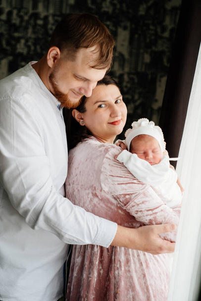 happy couple with a baby in arms. discharge from the hospital. first day at home - Фото, зображення