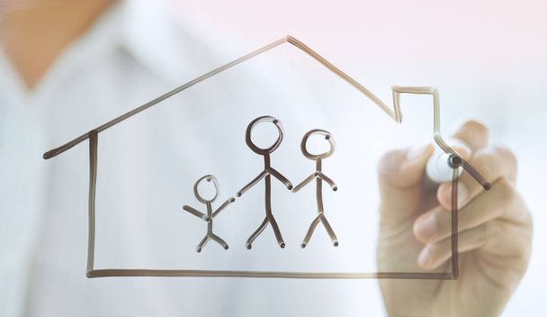 businessman drawing family icon and house for home and health insurance concept - Foto, afbeelding
