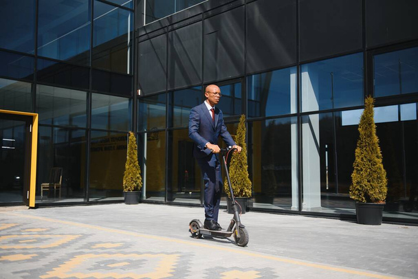 Young African businessman Riding An Electric Scooter - Photo, image