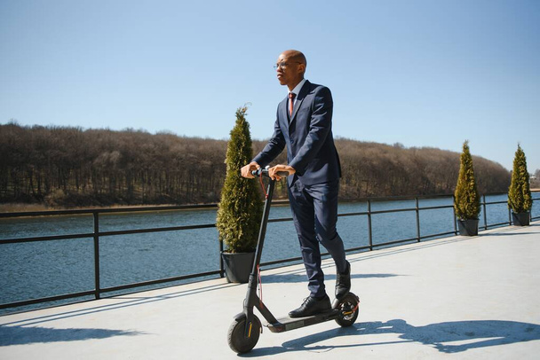 Young African businessman Riding An Electric Scooter - Foto, Bild