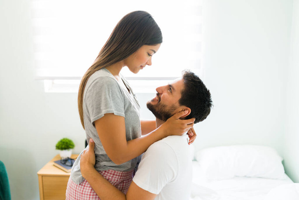 My boyfriend is everything to me. Loving young woman sharing a tender moment with her partner during a lovely morning in the bedroom - 写真・画像