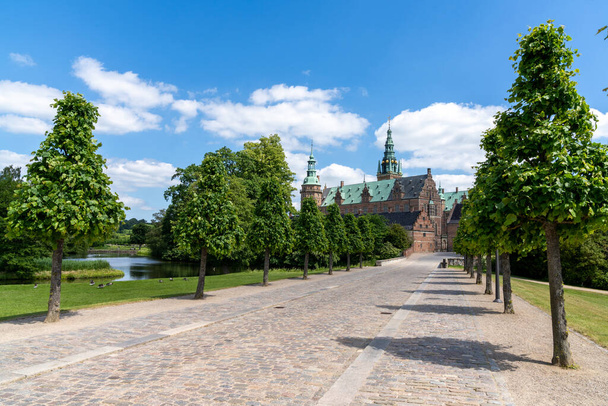 Hillerod, Denmark - 16 June, 2021: long tree-lined alley leading to the Frederiksborg Castle in Hillerod - Photo, image