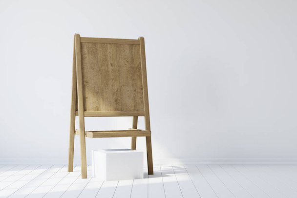 Wooden easel standing in an empty white room. 3d rendering - Photo, image