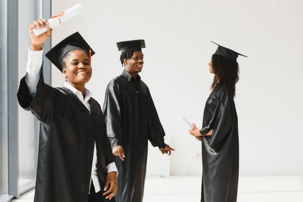 optimistic young university graduates at graduation - Φωτογραφία, εικόνα