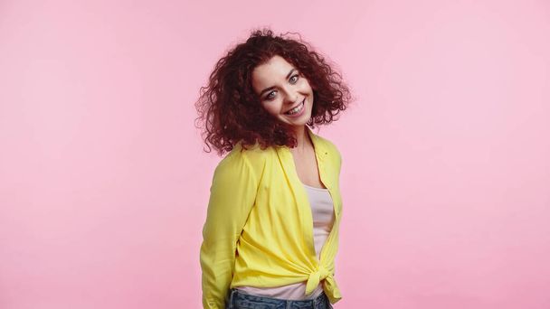 cheerful young woman in yellow shirt isolated on pink  - Photo, Image