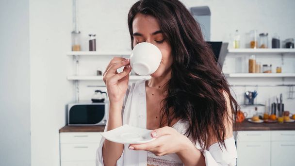 sensual brunette woman enjoying morning coffee with closed eyes - Foto, Bild