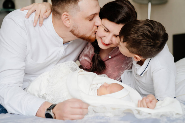 the first day of the newborn at home. Happy family with a toddler in the bedroom - Фото, зображення