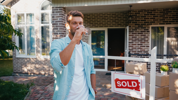 man holding glass and drinking wine near new house  - Photo, Image