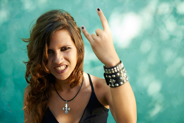 Portrait of young woman in heavy metal style - 写真・画像