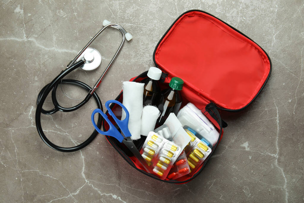 First aid medical kit on gray textured background - Foto, imagen
