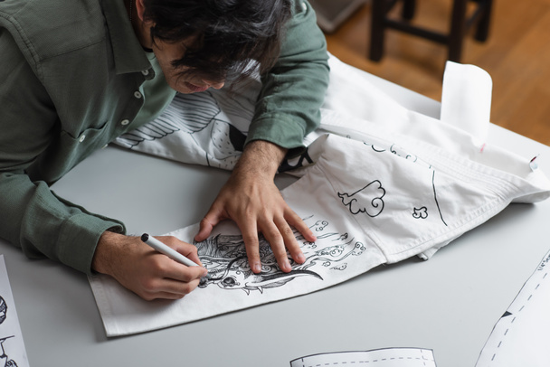 creative fashion designer creating traditional drawing on kimono - Photo, Image