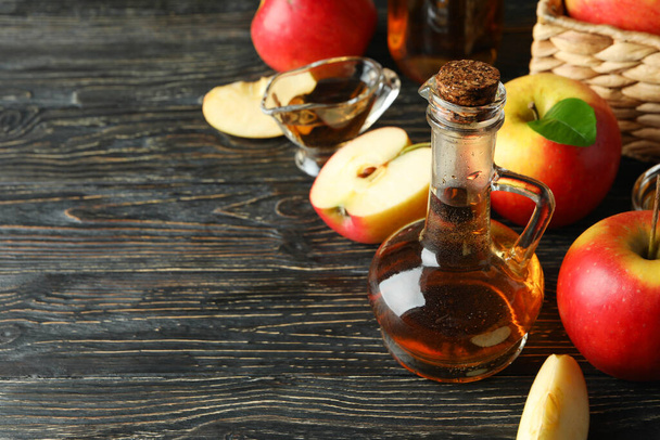 Homemade apple vinegar and ingredients on wooden table - Photo, Image