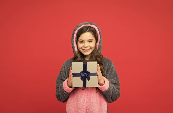 Shopping time. happy childhood. shopping gift for holiday. christmas or new year. cute kid in fluffy rabbit pajama hold present box. cheerful child celebrate birthday. teen girl enjoy boxing day - 写真・画像