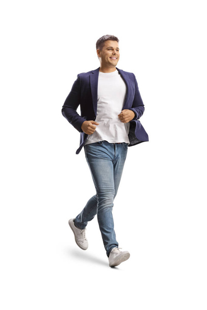 Full length shot of a man in jeans and suit running isolated on white background - Fotó, kép