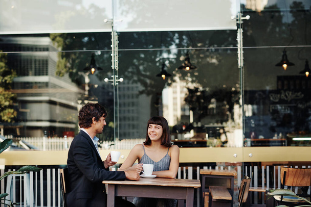 Shot of a young couple on a coffee date at a sidewalk cafe - Фото, зображення