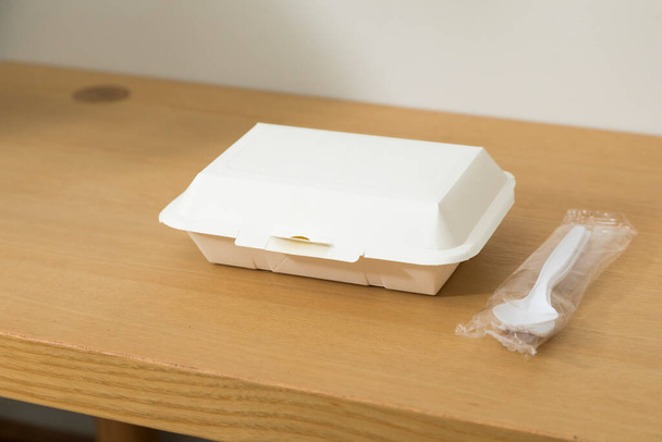 Service food delivery box or take away boxes, disposable eco friendly food packaging containers with spoon and fork on wooden table at home - Foto, afbeelding
