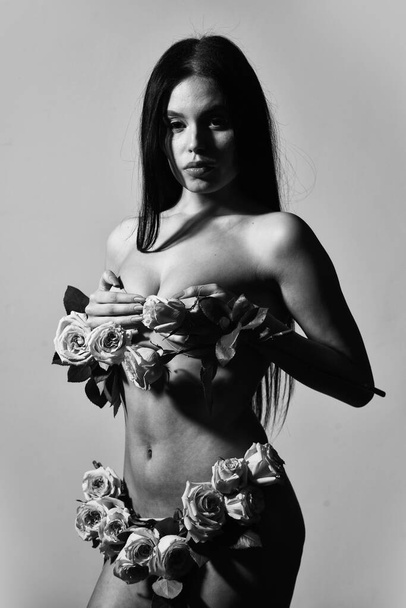 Spring freshness. love and romance. Spa treatments for skin rejuvenation. sexy naked woman hold rose flower. soft and tender. healthy woman hold rose with petals. sexy nude beautiful woman in flowers - Photo, Image