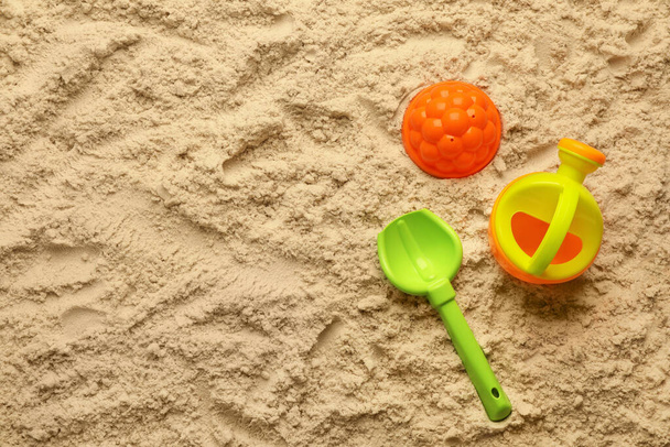 Flat lay of beach toy kit on sand, space for text. Outdoor play - Zdjęcie, obraz