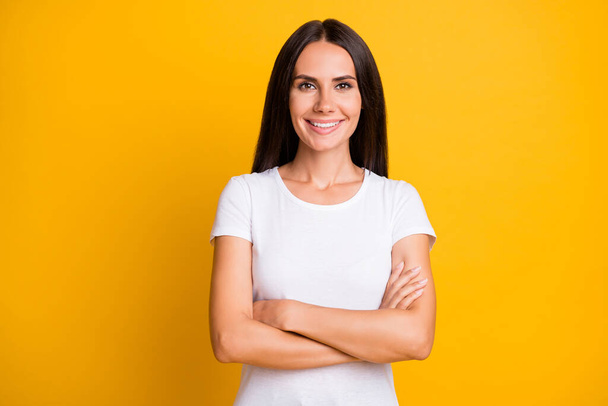Photo portrait of woman wearing white outfit smiling confident with folded hands isolated on bright yellow color background - Fotoğraf, Görsel