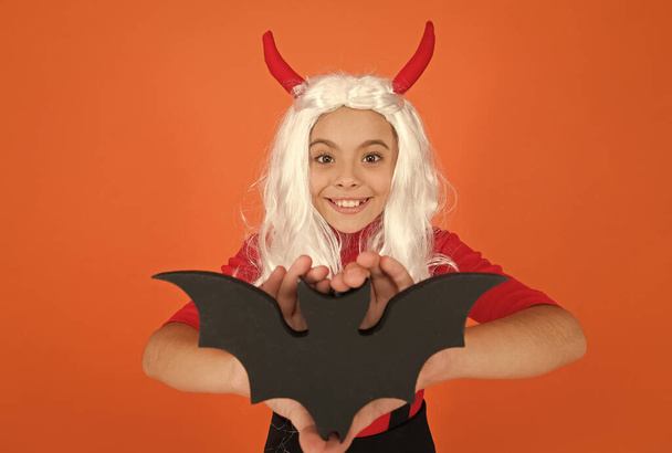 happy halloween. trick or treat concept. carnival festive costume of witch. kid with bat in white wig. child celebrate autumn holiday. teenage girl in devil horns celebrate halloween. selective focus - Foto, Imagen