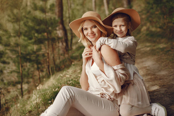 Elegant mother with daughter in a summer forest - Foto, afbeelding