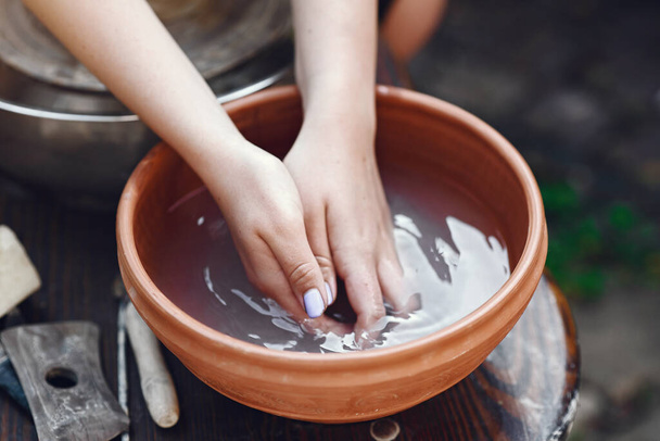People making a vaze from a clay on a potterys machine - Fotoğraf, Görsel