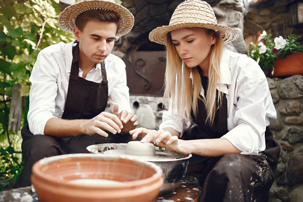 People making a vaze from a clay on a potterys machine - Zdjęcie, obraz