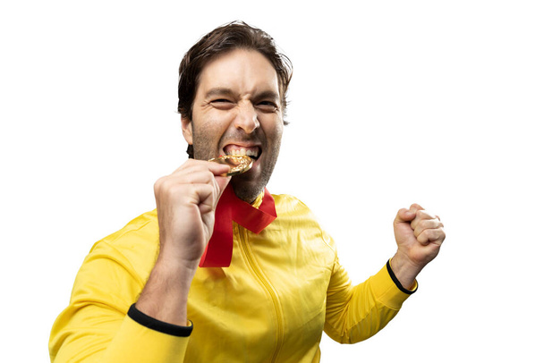 male athlete smiling after winning a gold medal in a white background. Sportsman with medal celebrating his victory. - Zdjęcie, obraz