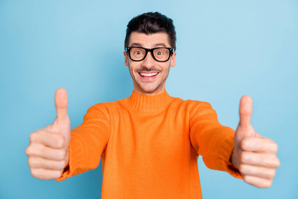 Portrait of cheerful handsome guy show two arms thumbs up beaming smile isolated on blue color background - Фото, зображення