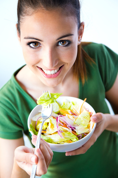 Woman eating salad. Portrait of beautiful smiling and happy Cauc - Fotó, kép