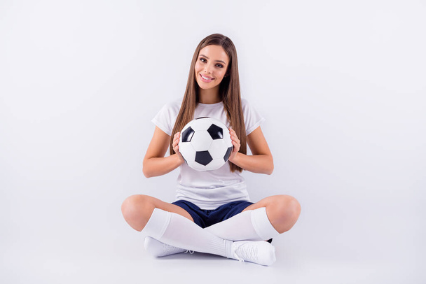 Portrait of her she nice attractive lovely sweet cute content cheerful straight-haired girl sitting in lotus pose position holding in hand ball isolated on light white gray pastel color background - 写真・画像