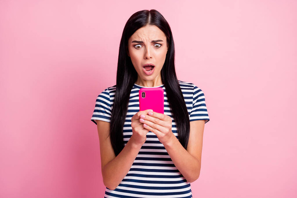 Close-up portrait of lovely worried desperate girl using gadget browsing media fake news isolated on pink pastel color background - Фото, изображение