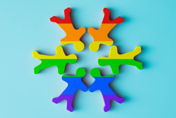 Houten speelgoedmensen in LGBT regenboogkleuren. LGBT-rechten. Gelijkheid van rechten. Mensenrechten en tolerantie. - Foto, afbeelding
