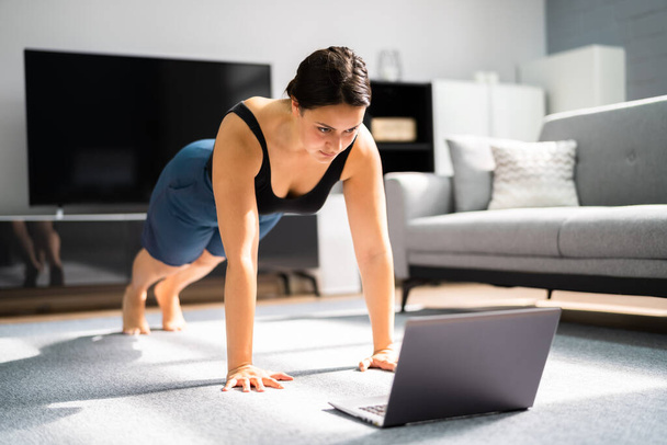 Woman Doing Online Fitness Workout At Home - Foto, Imagen
