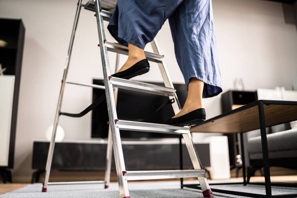 Ladder Safety. Woman Climbing Step Ladder In Shoes - Foto, Imagem