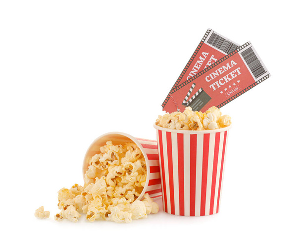 Buckets with tasty popcorn and cinema tickets on white background - Foto, afbeelding
