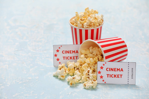 Buckets with tasty popcorn and cinema tickets on color background - Photo, Image