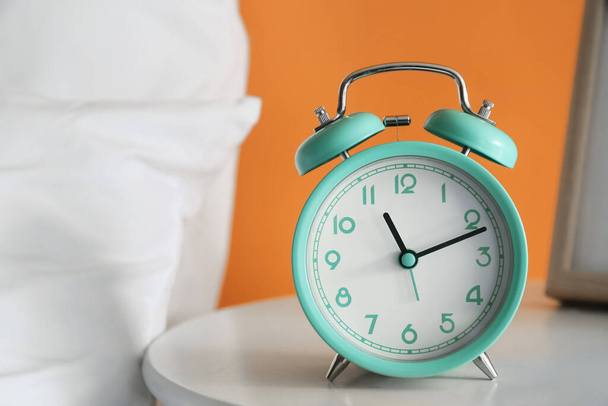 Alarm clock on bedside table, closeup - Фото, изображение