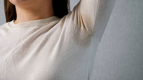 Wet armpit of an unrecognizable woman. Stress concept, hormonal disruption - Fotoğraf, Görsel