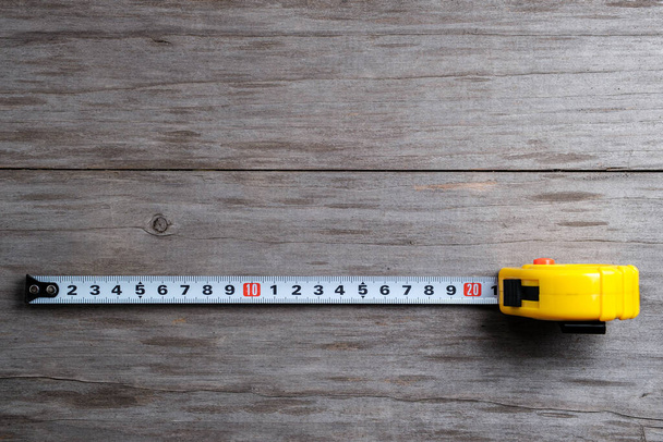 Measuring tape stretched 21 cm. Close-up. Selective focus. - 写真・画像