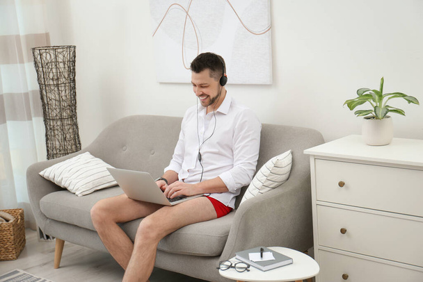 Businessman in underwear pretending to wear formal clothes during video call at home - Foto, Imagem